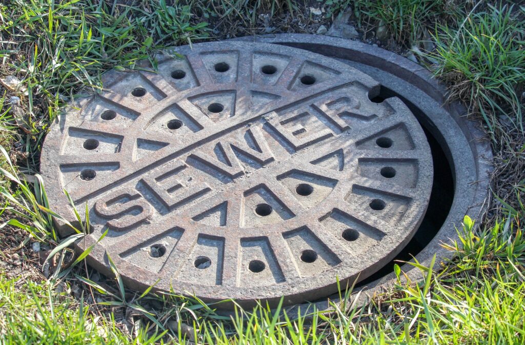 A manhole cover with the word sewer.