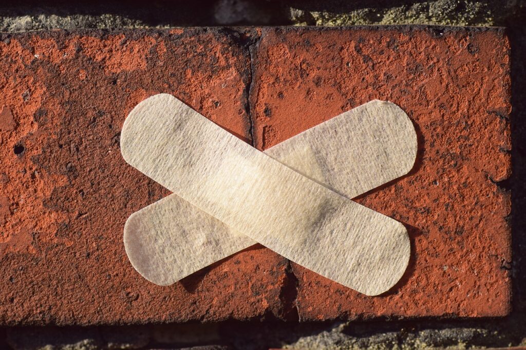 Bandages on a cracked brick. 
