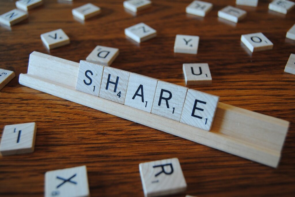 Scrabble tiles spelling out the word share. 